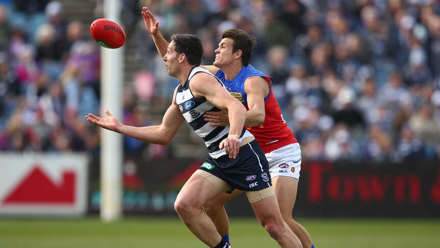 Always in front ... Harry Taylor (L) looks to control the ball for the Cats