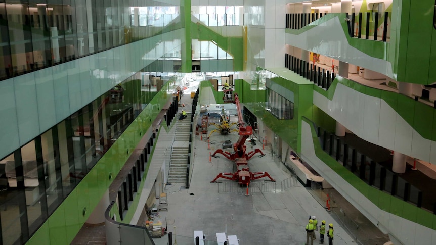 Looking down through internal atrium in Perth Children's Hospital with machinery and construction workers on the ground.