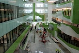 Looking down through internal atrium in Perth Children's Hospital with machinery and construction workers on the ground.