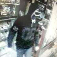 A man armed with a hammer in a Hawker bottle shop on June 17, 2014.