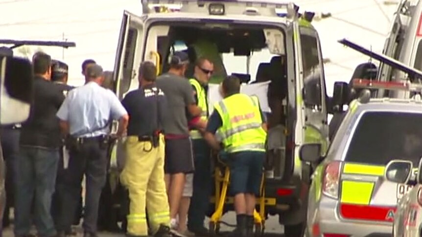 Person being loaded into ambulance after Brisbane siege