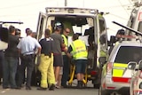 Person being loaded into ambulance after Brisbane siege