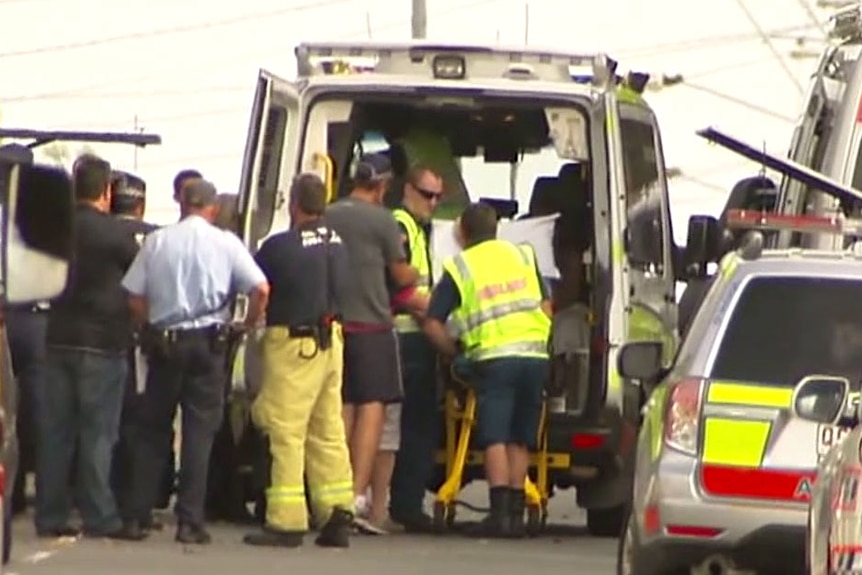 Person being loaded into ambulance after Brisbane siege