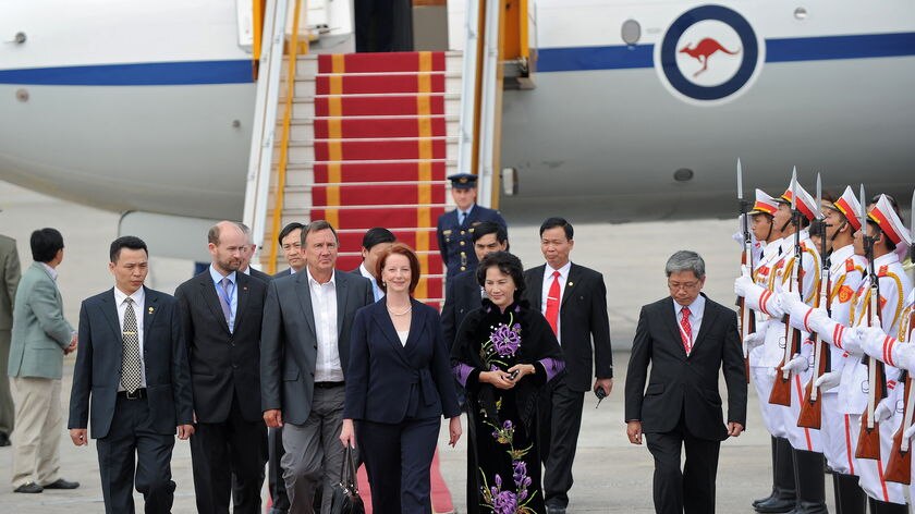 Prime Minister Julia Gillard and her partner Tim Mathieson arrive at Hanoi's international airport on October 29, 2010. (AFP)