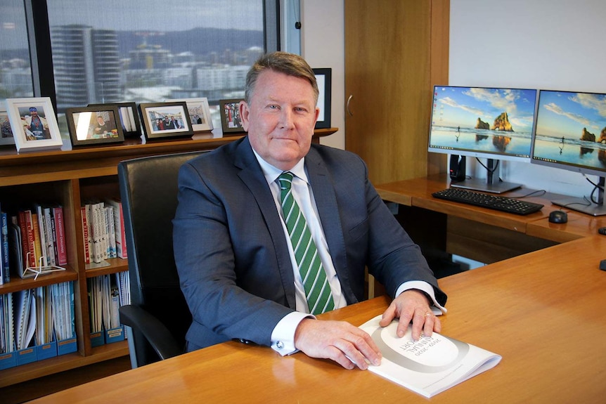 Chris Rider sitting at a desk in an office.