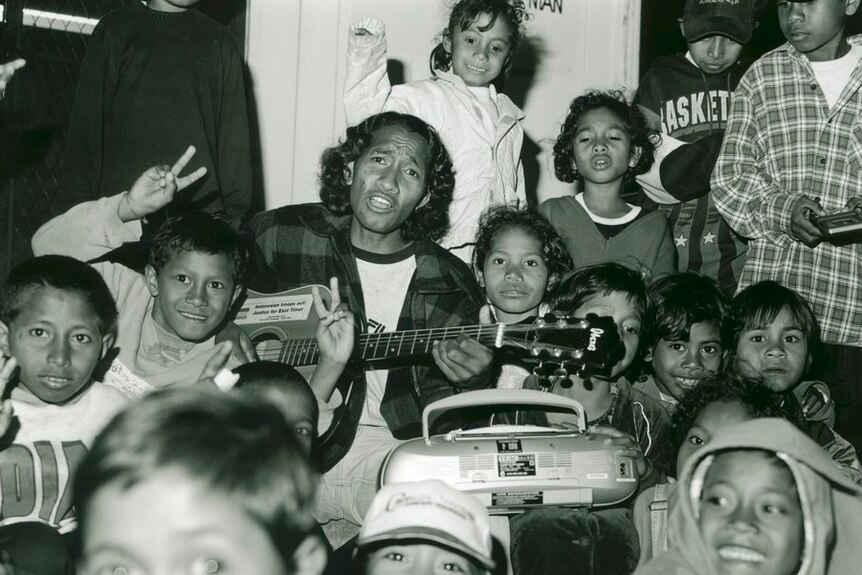 Alexandrino Da Costa, an East Timorese refugee, surrounded by East Timorese children at Puckapunyal , in 1999.