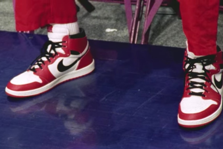 Michael Jordan's feet in a pair of red, black and white Air Jordan 1s before a game in 1998.