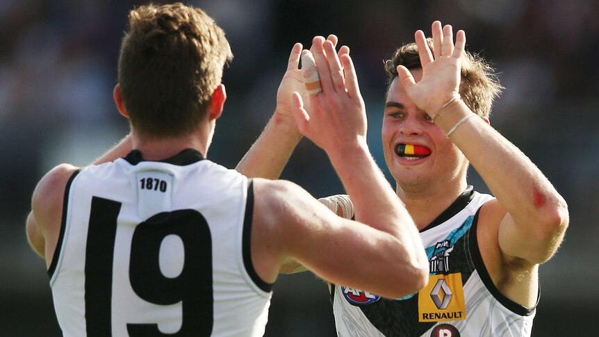 The Power's Matthew White (L) and Karl Amon (R) celebrate a goal against Melbourne in Alice Springs