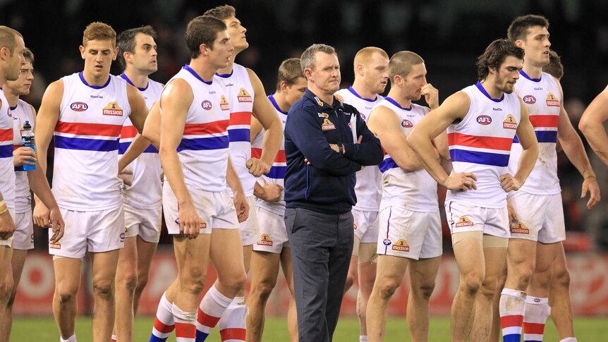 Coach Brendan McCartney with Western Bulldogs players at Docklands in June 2012.
