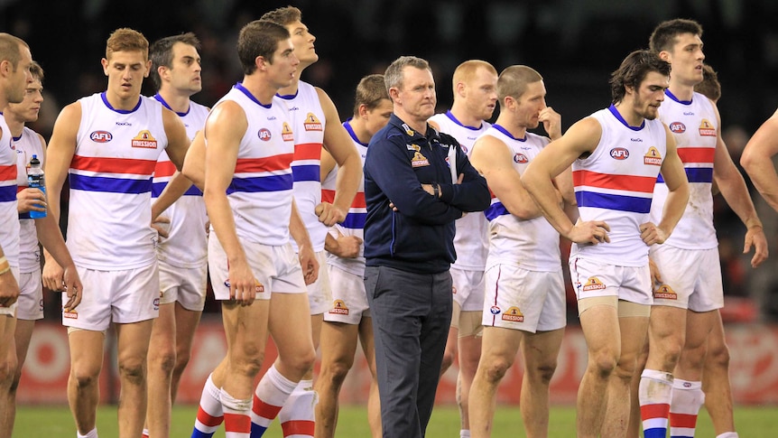 Coach Brendan McCartney with Western Bulldogs players at Docklands in June 2012.