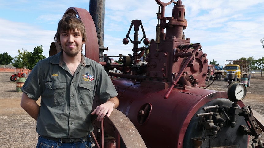 James Mergard leans on a vintage steam engine.