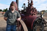James Mergard leans on a vintage steam engine.