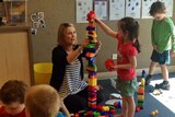 University of Tasmania lecturer Coleen Cheek helps a child at the early learning centre in Burnie.