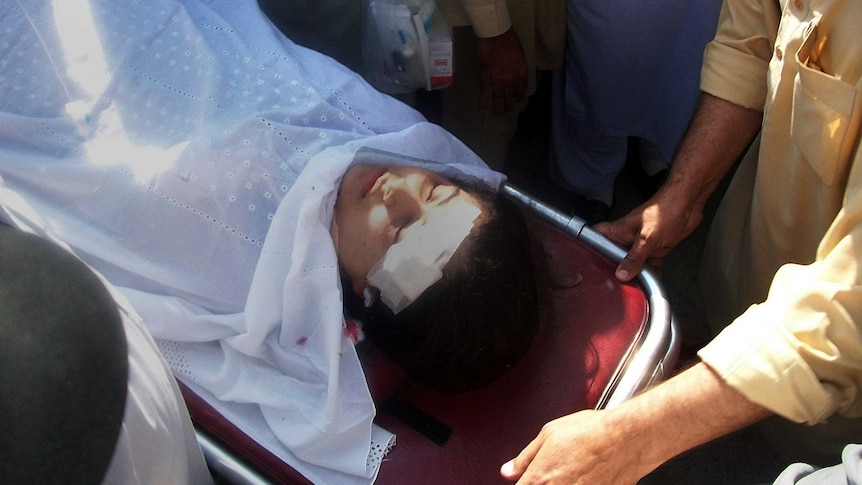 Pakistani hospital workers carry injured Malala Yousafzai