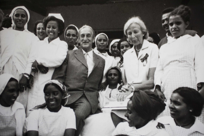 And older white couple pose with Ethiopia nurses in a black and white photo