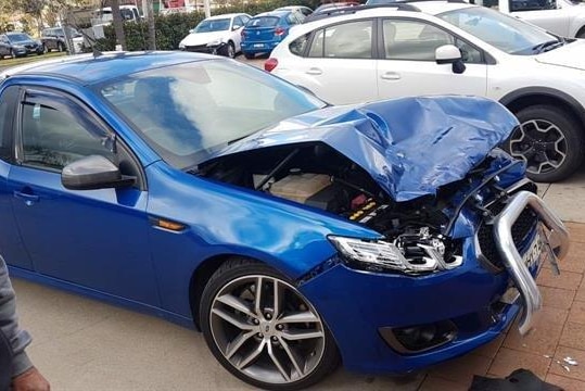 Blue ute crushed at bonnet and engine