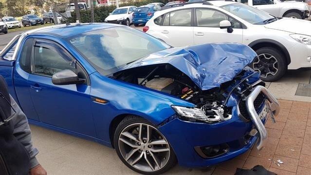 Blue ute crushed at bonnet and engine