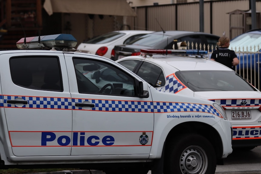 multiple police cars parked outside a home on a suburban street