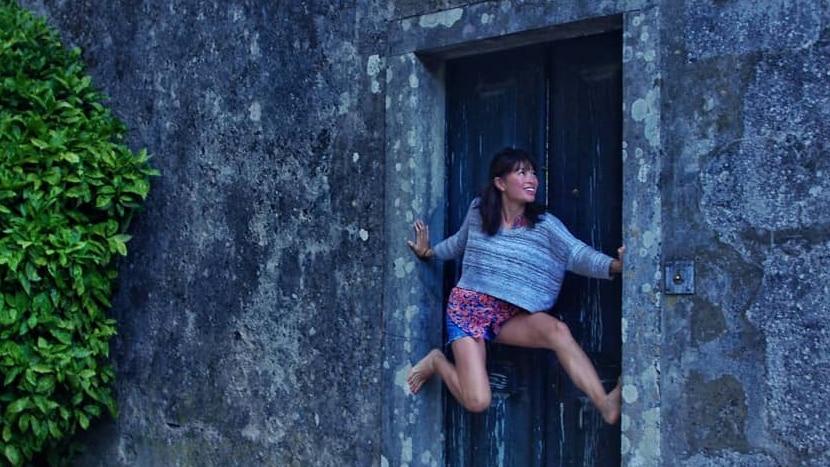 Amy Han balances between a doorway