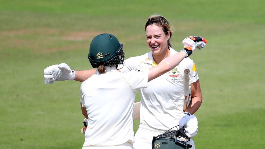 Ellyse Perry smiles as she huges Rachael Haynes to celebrate a century.