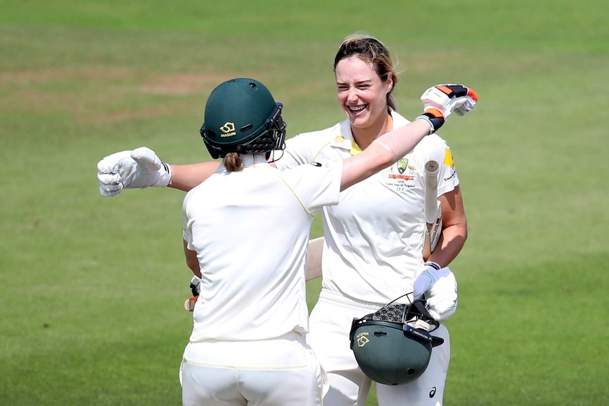 Ellyse Perry smiles as she huges Rachael Haynes to celebrate a century.
