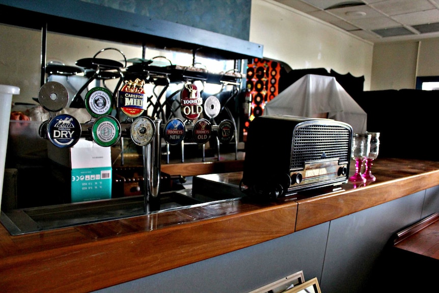 Old bar taps and vintage radio sitting on bar top in Railway Hotel.