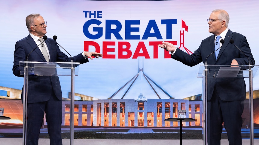 Anthony Albanese and Scott Morrison point at each other while debating on a TV set