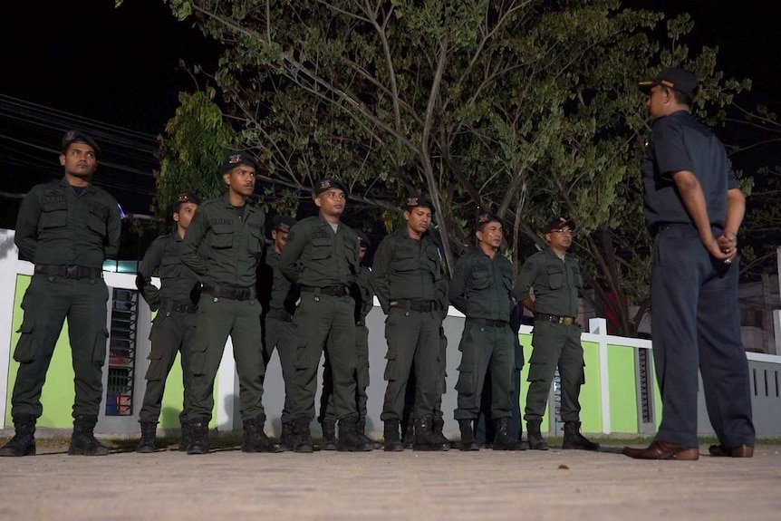 A superior officer briefs the officers before they head out.