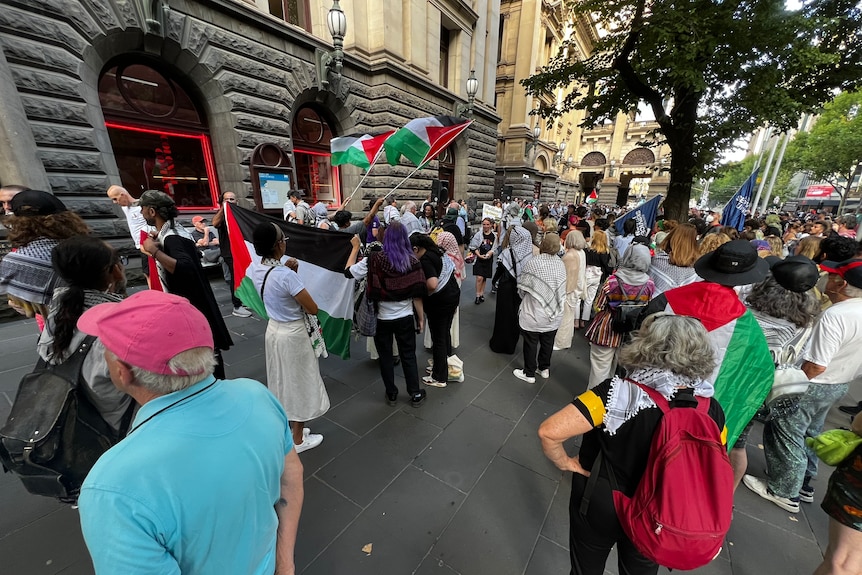 A group of protesters outside the City of Melbourne council building