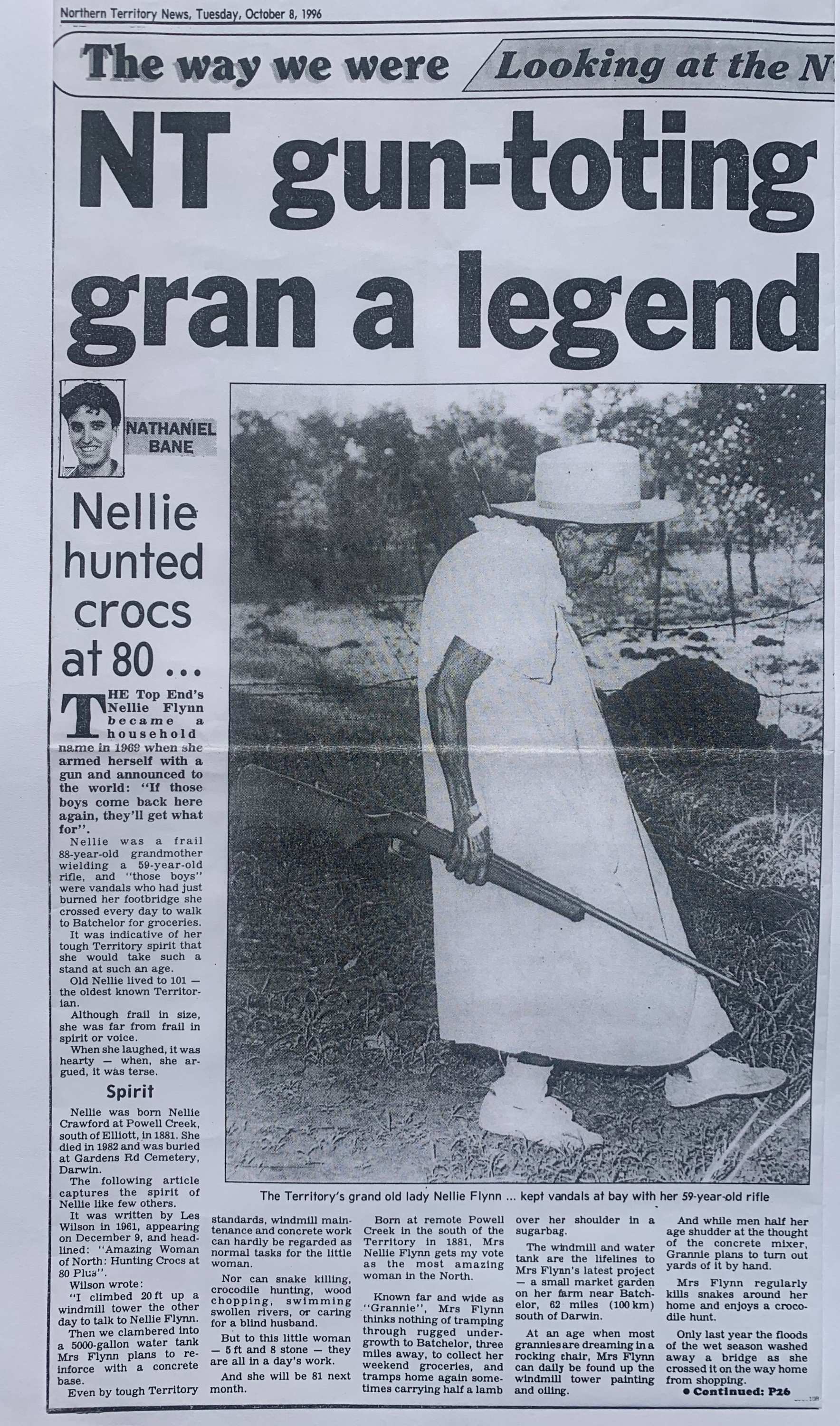 Photo of a newspaper page featuring black and white photo of short elderly woman holding a shotgun
