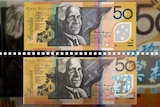 Composite image of fake and real Australian $50 notes.