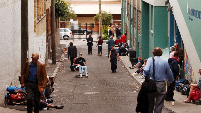 Homeless men gather in the laneway outside a men's hostel Matthew Talbot House in Kings Cross.
