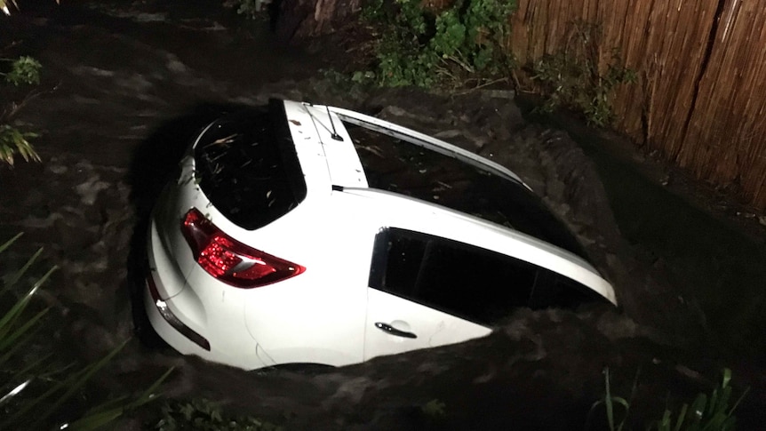 A car bobs in the floodwater.