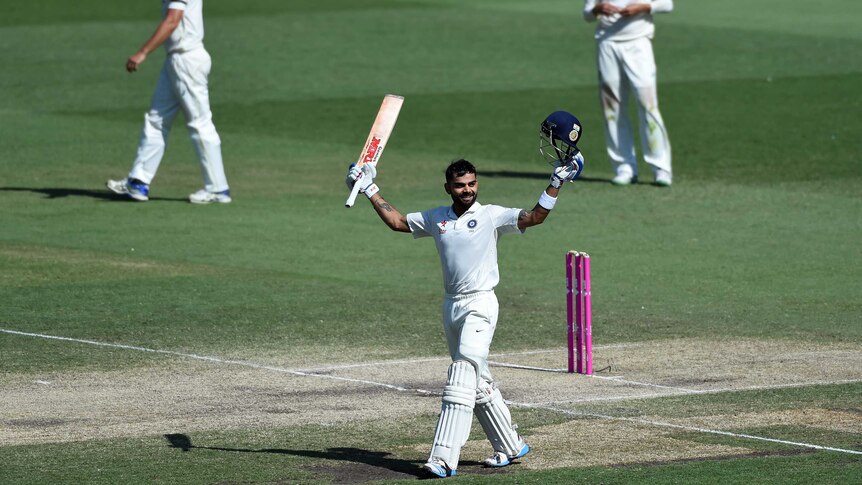 India's Virat Kohli (C) celebrates scoring a century against Australia at the SCG in January 2015.