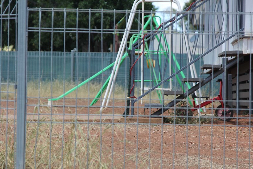 Play equipment in a bare dirt front yard in Mount Isa
