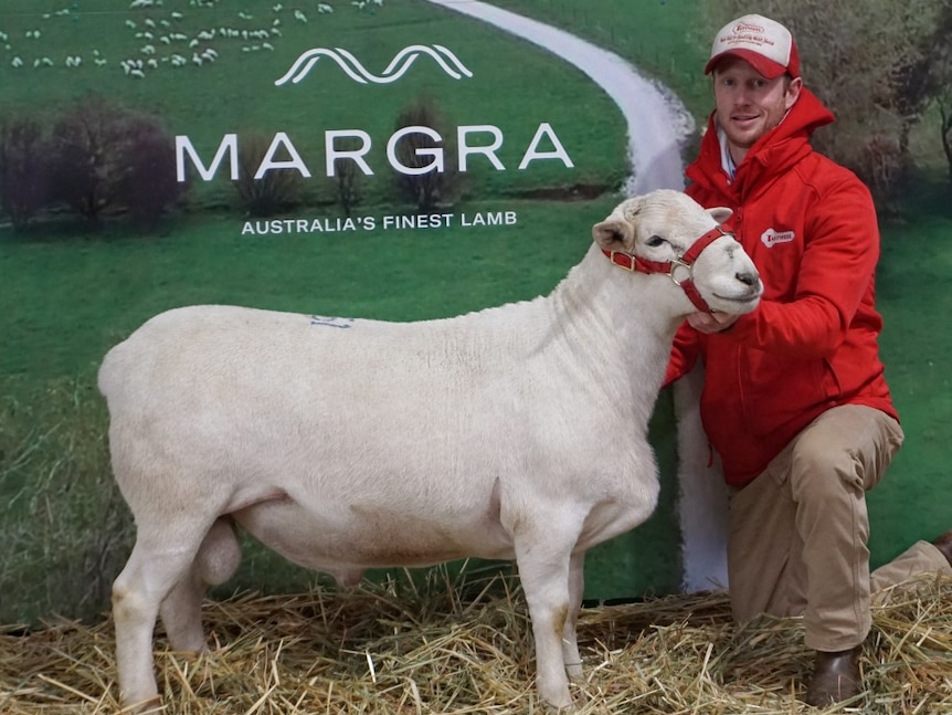 A man kneals next to a record ram