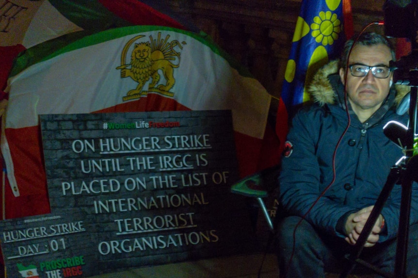 A man sitting in the dark protesting 