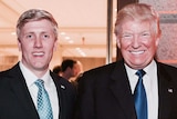 Donald Trump and Nick Ayers smile and give a thumbs-up as they stand next to eachother.