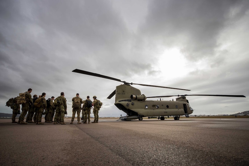 Soldiers and helicopter