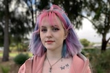 A young girl with coloured pink and blue hair