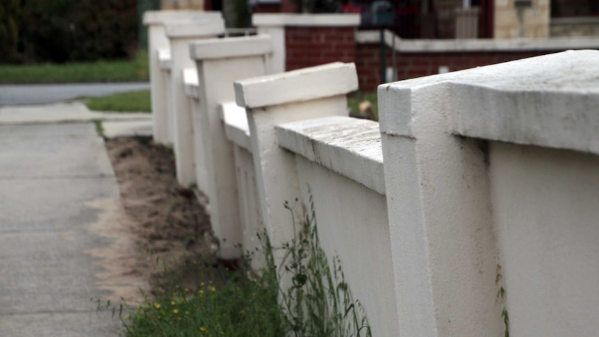 A damaged concrete fence surrounds a Perth property.