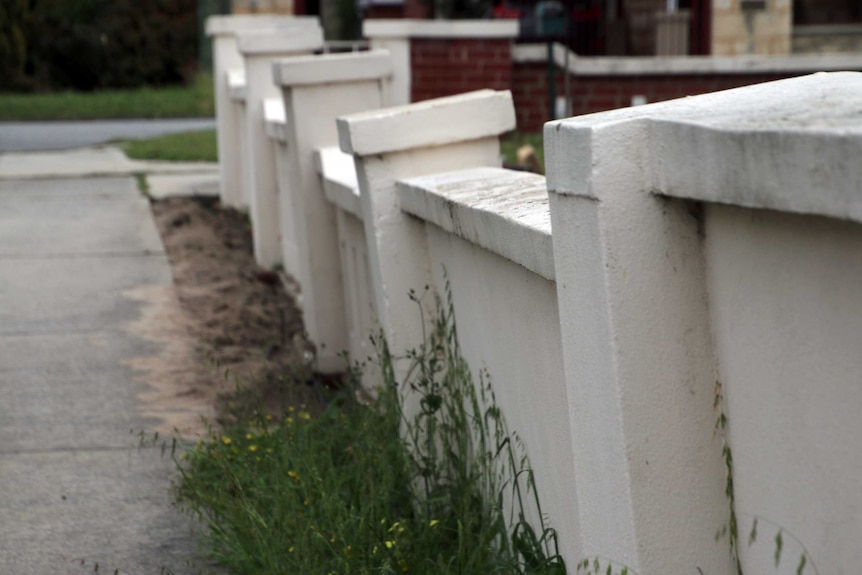 A damaged concrete fence surrounds a Perth property.