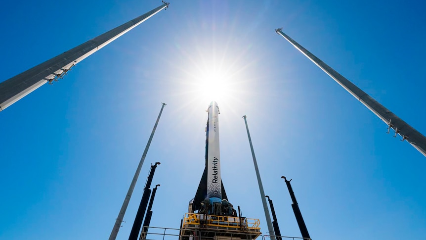 Relativity Space's Terran 1 rocket stands tall in front of the Sun.