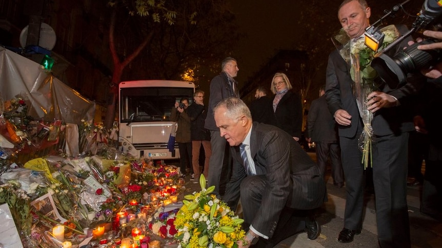 Malcolm Turnbull lays flowers outside the Bataclan theatre in Paris.