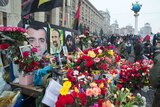 Mourners place flowers at memorial in Kiev