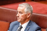 Gerard Rennick sits on the backbench in the Senate looking into the distance