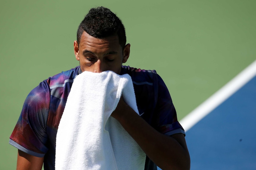 Nick Kyrgios wipes his face with a towel after a point against John Millman at the 2017 US Open.