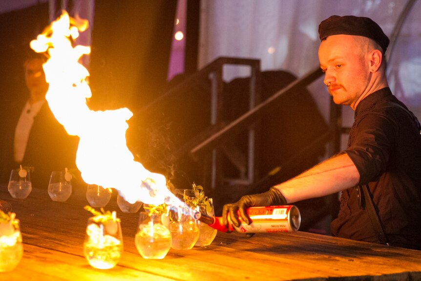 Cocktails set alight as showgoers enter the performance.