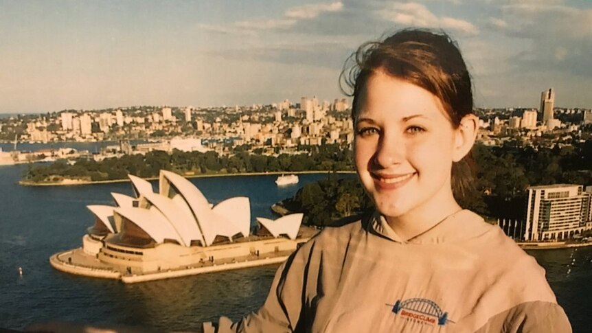 An old photograph of a 14-year-old girl with the Opera House in the background.