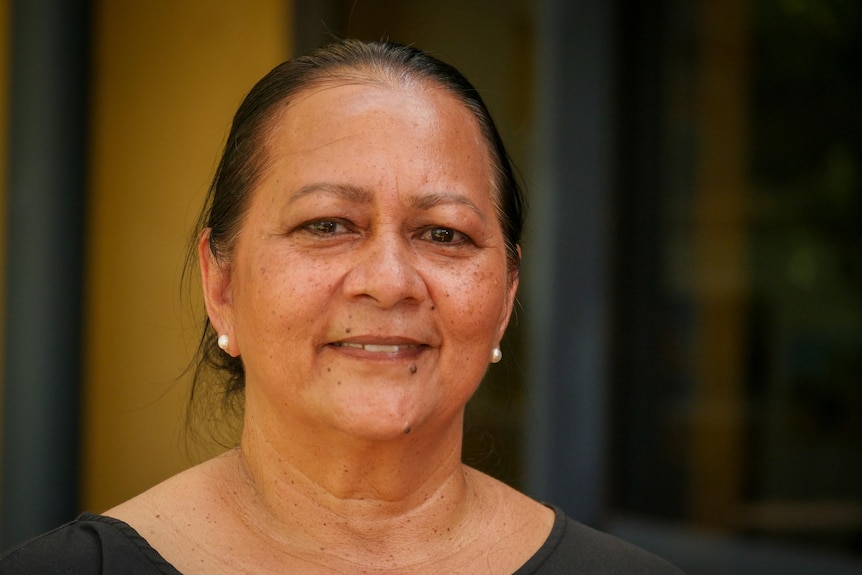 A woman smiles for the camera.